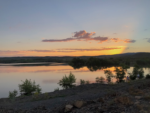 Sunset over the river in the Altai mountains