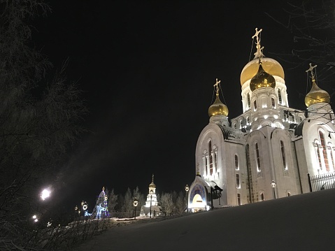 Church with golden domes on the hill in the evening