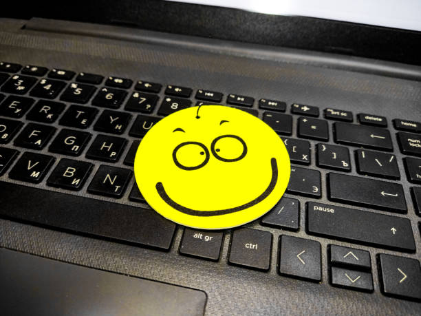 yellow smiley face on laptop keyboard