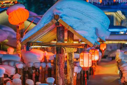 Winter Season Snow Town Xuexiang with chinese lantern deep snow at night Colorful lighting on Snow-Covered houses