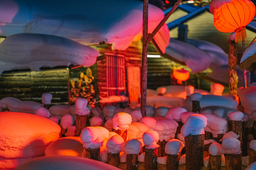 Winter Season Snow Town Xuexiang with chinese lantern deep snow at night Colorful lighting on Snow-Covered houses