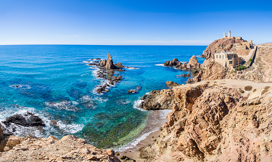 The Lighthouse of Cabo de Gata, built in 1863, and the Arrecife de las Sirenas, rock formations of volcanic origin in the southeastern edge of the Cabo de Gata-Níjar Nature Reserve (4 shots stitched)