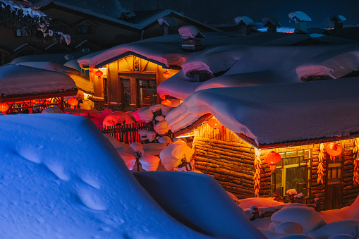 Winter Season Snow Town Xuexiang with chinese lantern deep snow at night Colorful lighting on Snow-Covered cottage