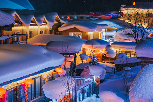 Winter Season Snow Town Xuexiang with chinese lantern deep snow at night Colorful lighting on Snow-Covered houses