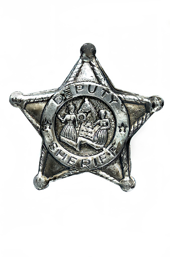 An old six star brass sheriff badge with  a clipping path.