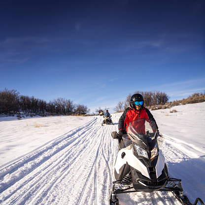 Young man driving a snowmobile in Colorado, USA