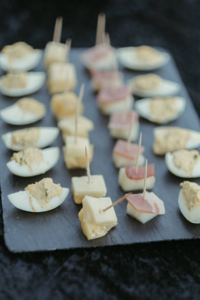 istock the black slate plate holds mini appetizers on a table 1917346075