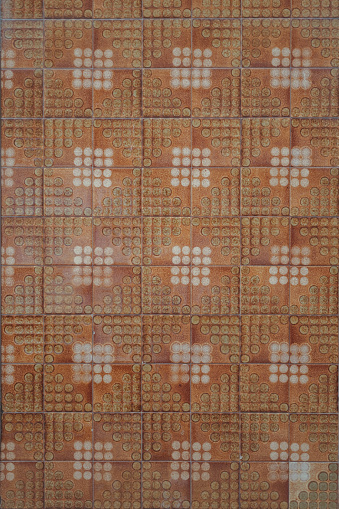 This is a stock photo of a red and brown mosaic tile pattern