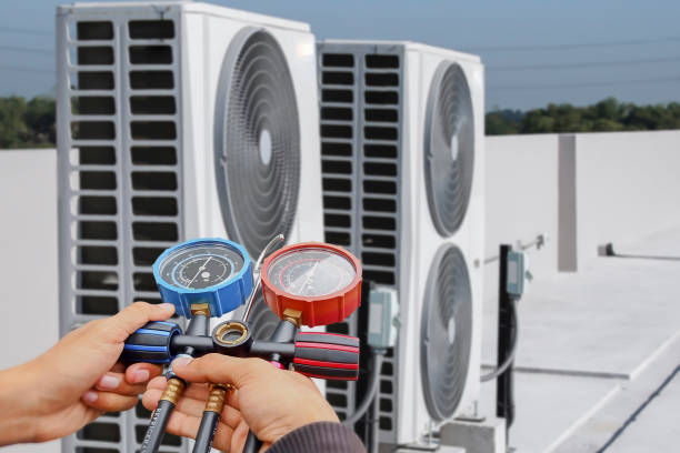 istock Air conditioning, HVAC service technician using gauges to check refrigerant and add refrigerant. 1917354199