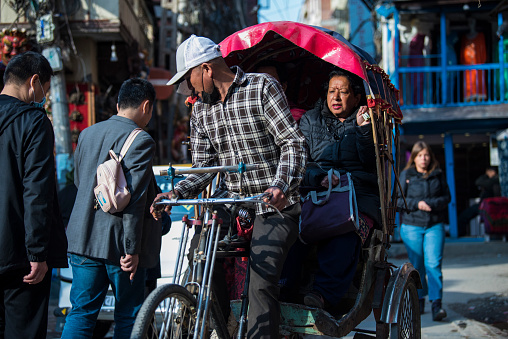 Kathmandu, Nepal - April 20,2019 :  In Nepal cycle rickshaws are still the most popular means of public transport for short-distance commuting.