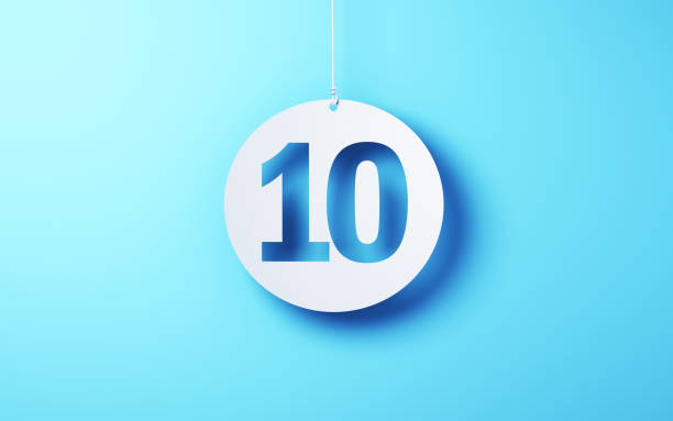 istock Number 10 cut on white note paper hanging on string, White note paper blue background 1917389641