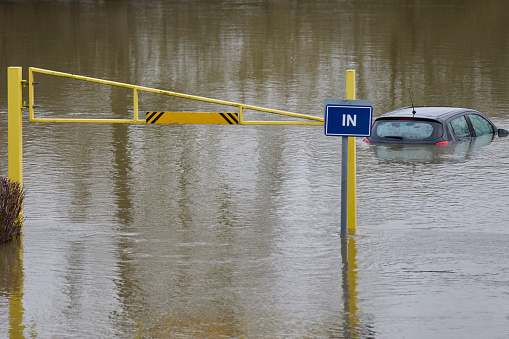 Abandoned Car Submerged In Flood Water In Parking Lot In Oxfordshire UK January 2024