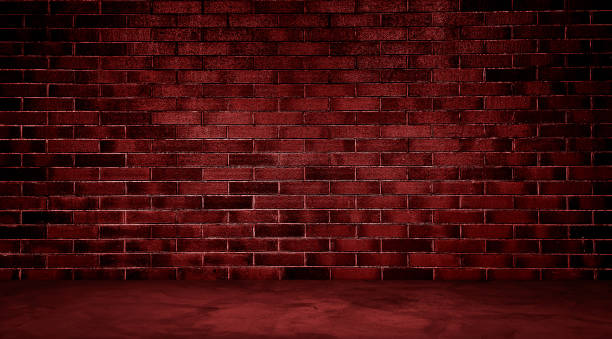 istock dark room with red concrete floor and red brick wall background. empty room for montage product displayed in rustic, industrial, loft mood and tone. room interior with red light for design. 1917394425