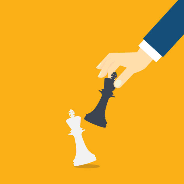 istock Hand holding black chess king and knocking down white one, checkmate. Business Strategy concept. 1917394431