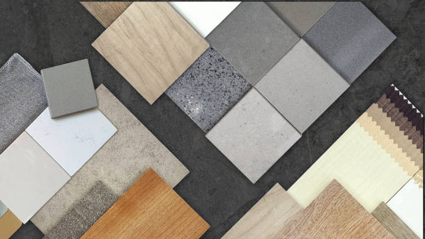 istock top view of interior material samples board including artificial stones, wooden tiles, concrete vinyl flooring tile, drape catalog, fabric placed on dark black marble table background. 1917394440