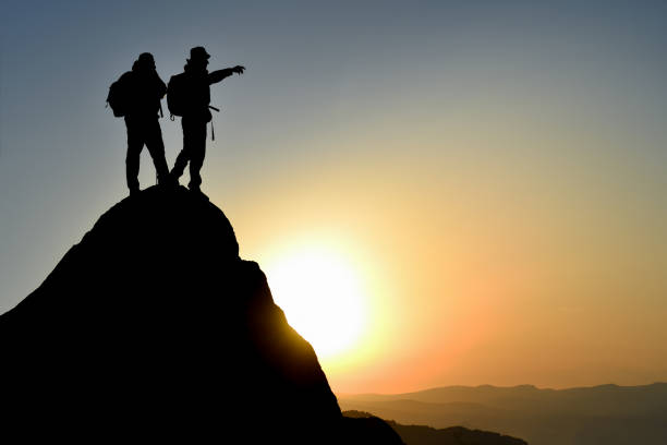 istock Victory at Sunrise: Epic Memories of Two Climbers at the Top 1917411380