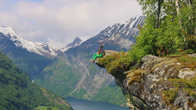 Woman Admiring Scenic Summer Mountain Landscape of Geirangerfjord from Above