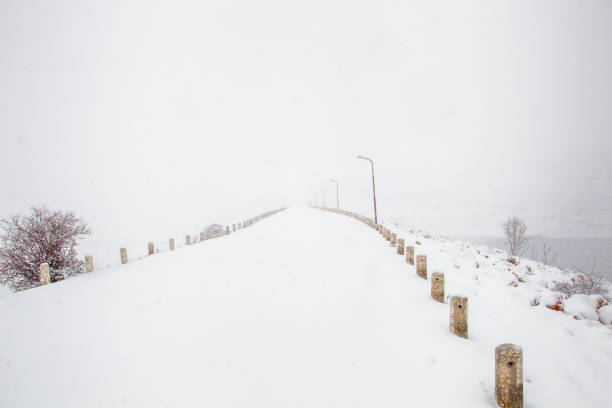A road in Fisandun Village in the center of Karaman and Snow and Poles on the Road\n​