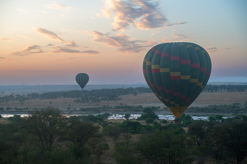 the Mara from above – the Mara River seen from above aboard a hot air balloon with other hot air balloons around, with beautiful morning light at sunrise - Serengeti – Tanzania