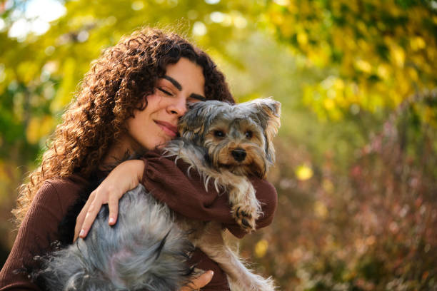 istock Young Caucasian woman hugging her Yorkshire Terrier dog. 1917452919
