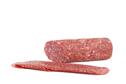 heap of slices of cervelat sausage isolated on white background. High quality photo