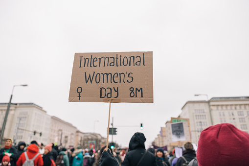 Unrecognizable person holding a banner for International Women's Day