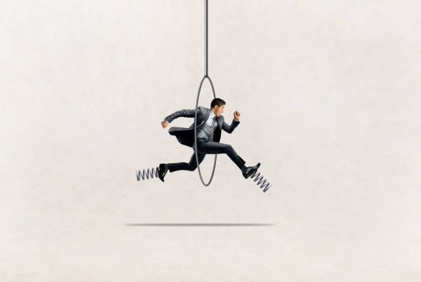 istock Businessman Jumping Through Hoop 1917490813