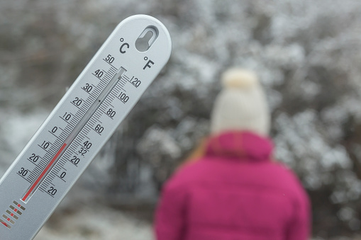 Thermometer with Zero degree Celsius temperature outdoor on cold winter day
