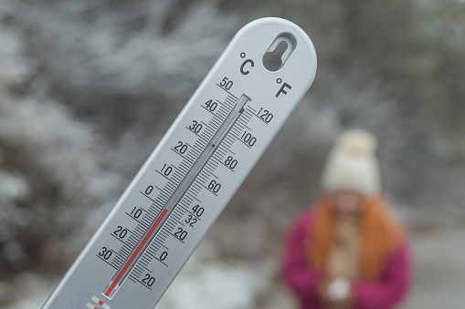 Thermometer with Zero degree Celsius temperature outdoor on cold winter day