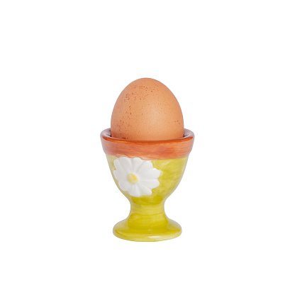 Brown chicken egg in a egg cup isolated on white background-clipping path