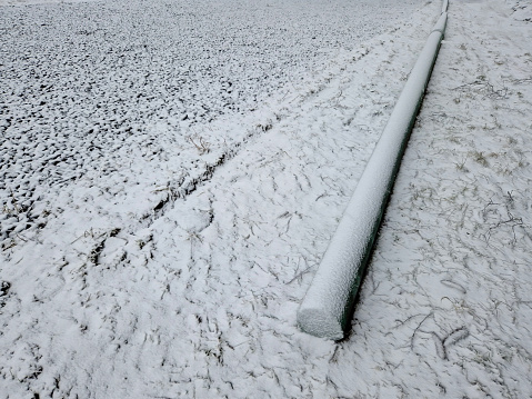 barriers made of concrete electric pylon. serves as a barrier to the entrance to the park and the pedestrian zone. whole cubes are under a layer of snow.