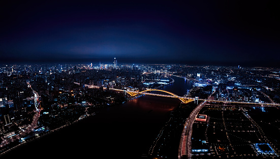 Bird's-eye view of Lupu Bridge and high-rise buildings on both sides of the Huangpu River in Shanghai, China at night