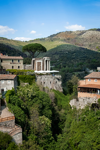 panorama of the ancient temple of the sibyl in Tivoli, surrounded by urban area and lush green environment