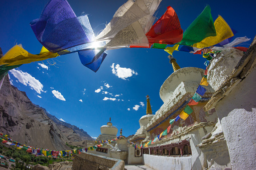 A Tibetan prayer flag is a colorful rectangular cloth, often found strung along trails and peaks high in the Himalayas. They are used to bless the surrounding countryside and for other purposes. Prayer flags are believed to have originated within the religious tradition of Bon. In Bon, shamanistic Bonpo used primary-colored plain flags in Tibet. Traditional prayer flags include woodblock-printed text and images.