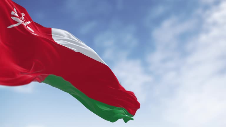 National flag of Oman waving in the wind on a clear day