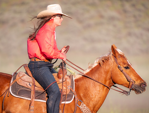 A side view of a woman riding in rural Utah, USA.