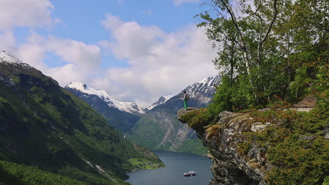Woman Admiring Scenic Summer Mountain Landscape of Geirangerfjord from Above