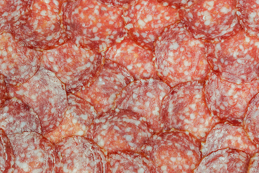 Texture of fresh sausage salami. Top view, copy space.