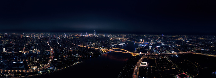 Bird's-eye view of Lupu Bridge and high-rise buildings on both sides of the Huangpu River in Shanghai, China at night