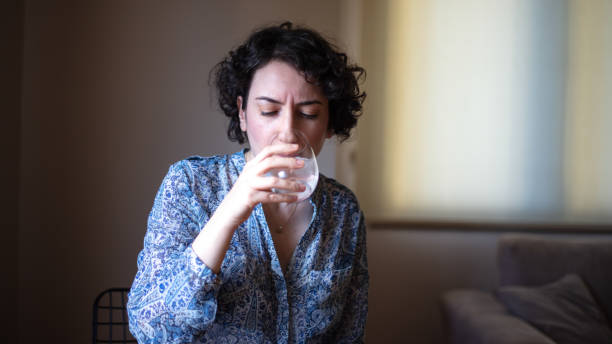 istock Young lady is experiencing tooth sensitivity in living room. 1917593007