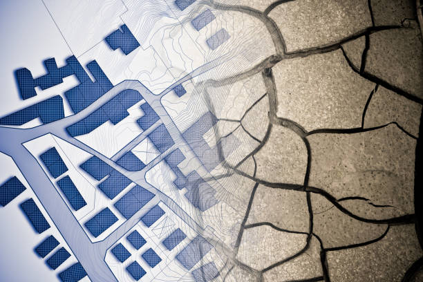 istock Cracked ground view from above - concept image with an imaginary cadastral map of territory with buildings, roads and land parcel 1917616147
