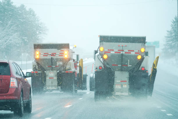 istock Snowplow truck spreading salt on the highway 1917625551