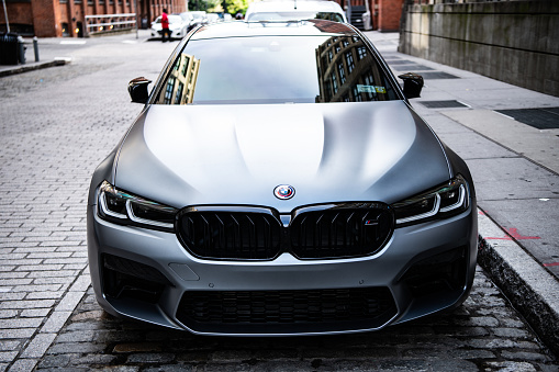 New York City, USA - July 15, 2023: BMW F90 M5 grey color car parked, front view.