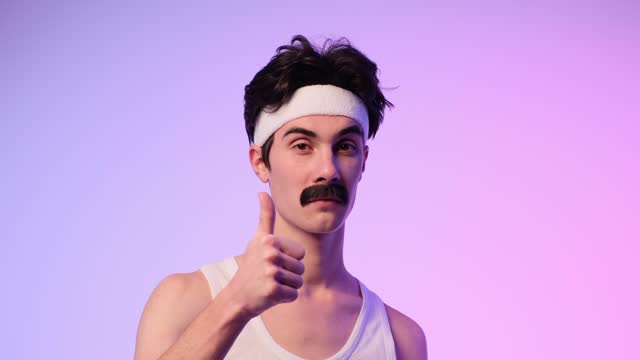 Confident Mustached Caucasian Man Gives Thumbs Up on Purple Background
