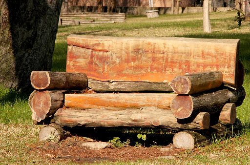 a bench made from logs in a park