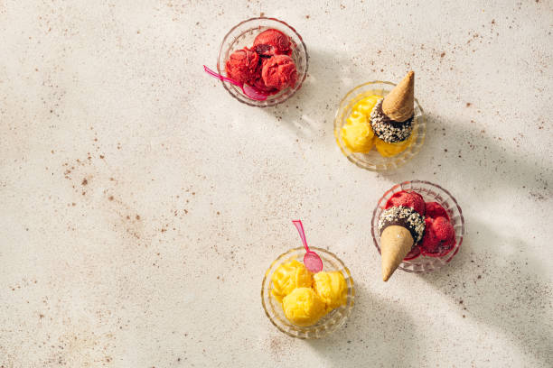istock Mango and raspberry sorbet in glass bowls top view 1917716833