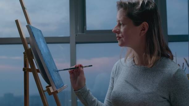 istock Attractive young painter artist with paintbrush and canvas 1917741201