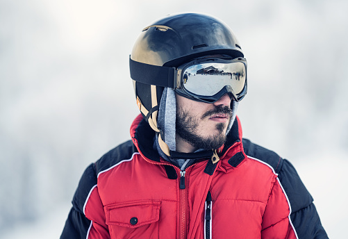 Young man wearing ski clothes and helmet portrait