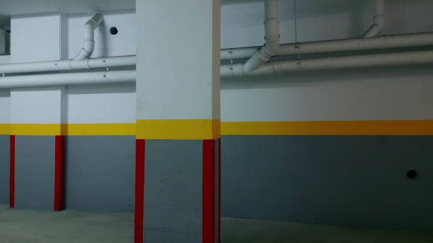 istock Dark empty building corridor painted in gray yellow red colours with collouns. 1917786667