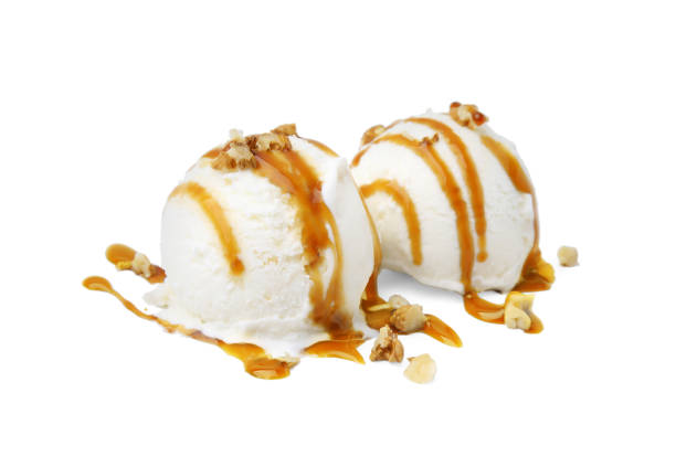 istock Scoops of ice cream with caramel sauce and nuts isolated on white 1917801184